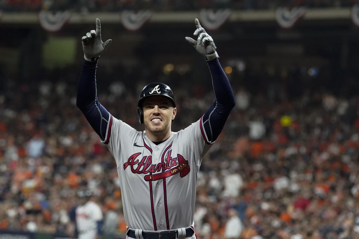 Atlanta Braves' Freddie Freeman celebrates his home run during the seventh inning in Game 6 of baseball's World Series between the Houston Astros and the Atlanta Braves Tuesday, Nov. 2, 2021, in Houston.(AP Photo/Eric Gay)