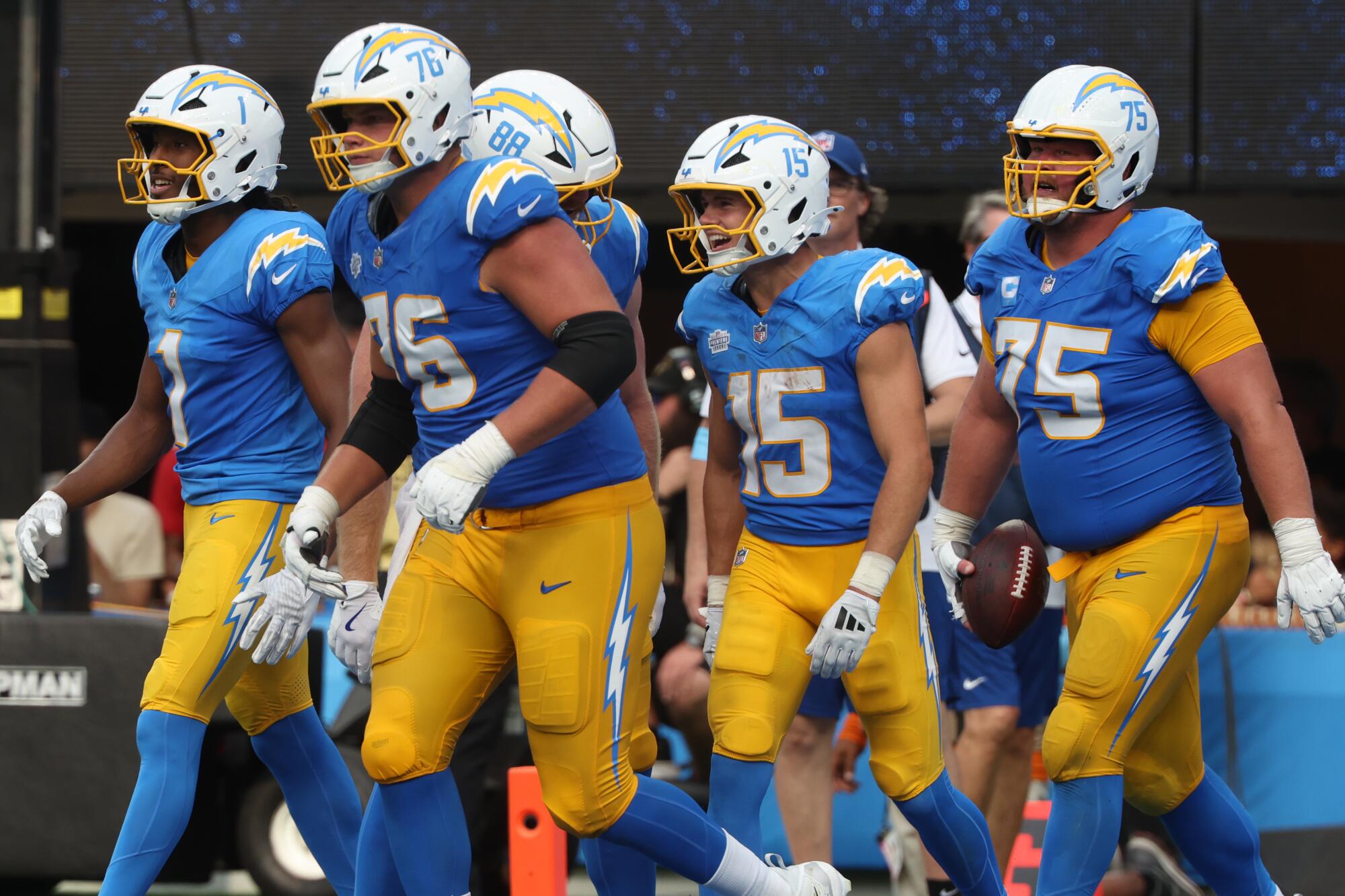 Chargers wide receiver Ladd McConkey celebrates with teammates after catching a touchdown pass against the Raiders.