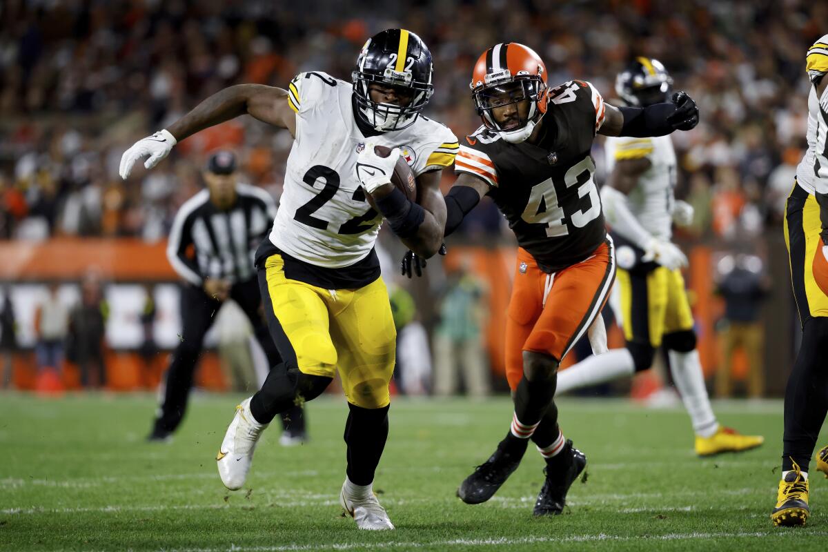 Pittsburgh Steelers running back Najee Harris runs past Cleveland Browns safety John Johnson III.