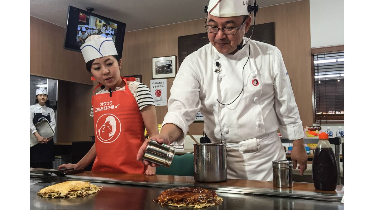 Yoshihiro Ueuchi teaches visitors to Hiroshima's Wood Egg how to make okonomiyaki.