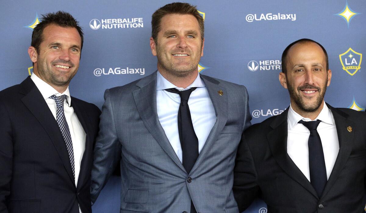 New Galaxy Coach Curt Onalfo, center, is flanked by President Chris Klein, left, and General Manager Peter Vagenas at a news conference in Carson on Dec. 13, 2016.