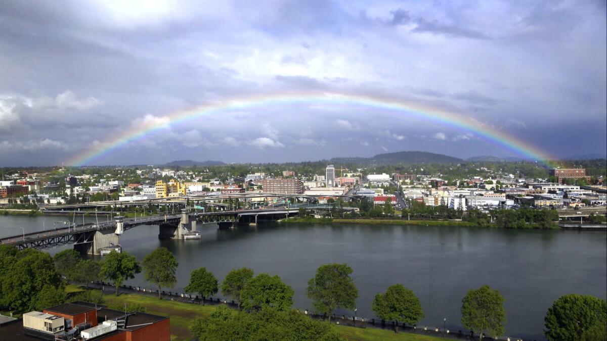 A rainbow pops out over the Willamette River in downtown Portland, Ore. You can fly for $138 round trip from Aug. 21 through Feb. 13.