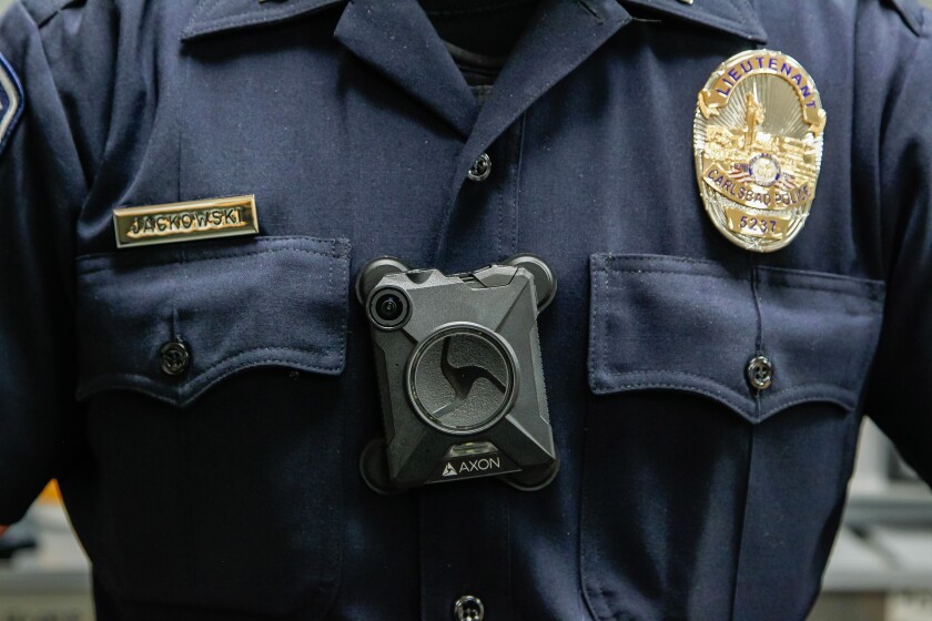 In this 2016 file photo a Carlsbad Police Department lieutenant demonstrates a police body camera.