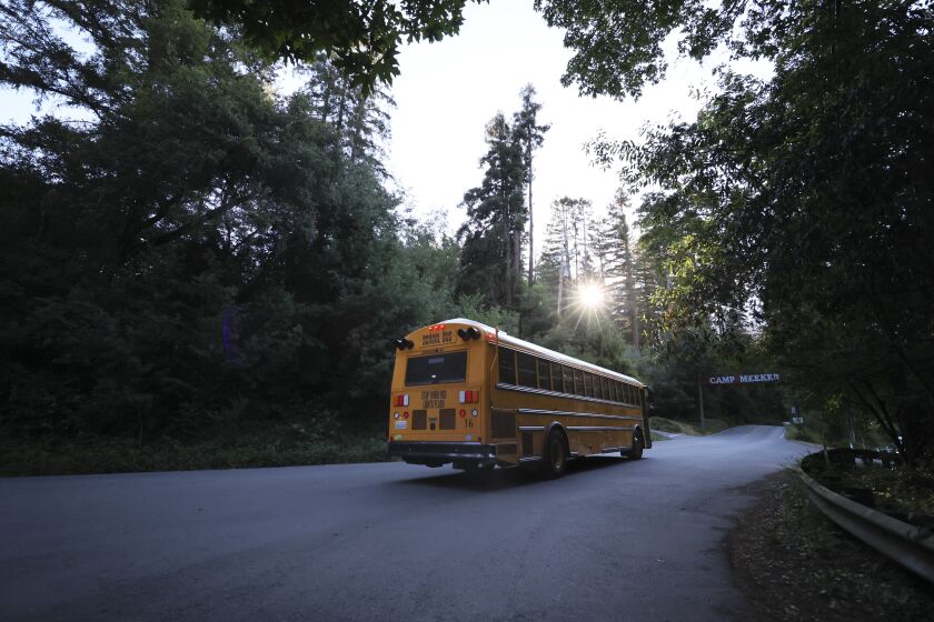 CAMP MEEKER CA MAY 31, 2022 - A school bus picks up students in the morning heading for West Sonoma County Union High School District on Tuesday, May 31, 2022 in Camp Meeker, Calif. (Paul Kuroda/For The Times)