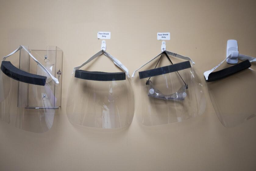 APPLE VALLEY, CA - DECEMBER 22: During the global coronaviras pandemic face shields hang on the wall inside Providence St. Mary Medical Center in Apple Valley, CA on Tuesday, Dec. 22, 2020 in Apple Valley, CA. According to the hospital they are currently at 250% capacity. Presently they have 130 covid possitive cases and 16 suspected possitives admitted. (Francine Orr / Los Angeles Times)