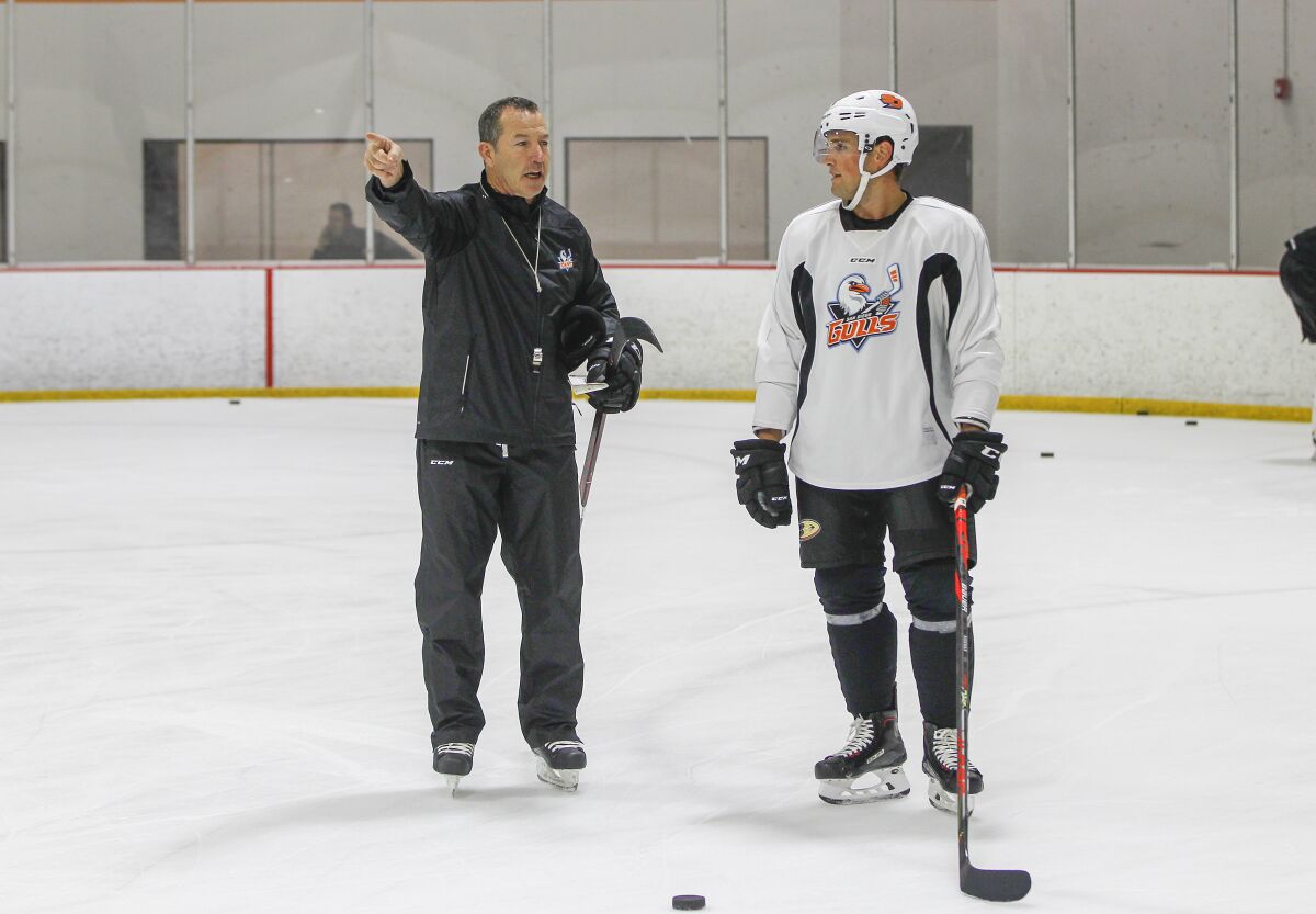 Kevin Dineen, new coach of the San Diego Gulls, works with Chris Wideman this week at practice in Poway.
