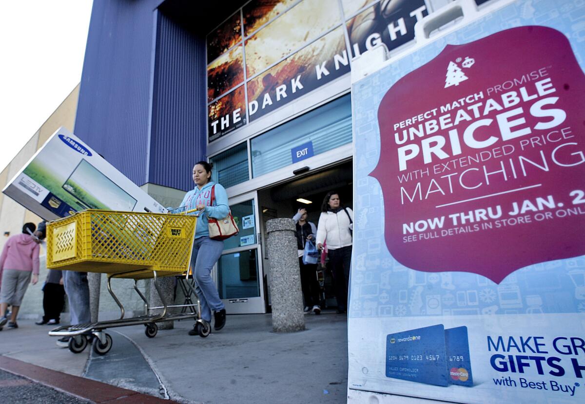 Customers purchase large items like television sets from the Empire Center's Best Buy in Burbank on Friday, Nov. 23, 2012. A 24-year-old Best Buy employee was arrested Wednesday, Sept. 18, 2013 after allegedly stealing $1,100 from the Empire Center store through fraudulent returns, police said.