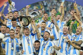 Argentina's Lionel Messi holds the trophy as celebrating with teammates after defeating Colombia in the Copa America final soccer match in Miami Gardens, Fla., Monday, July 15, 2024. (AP Photo/Rebecca Blackwell)