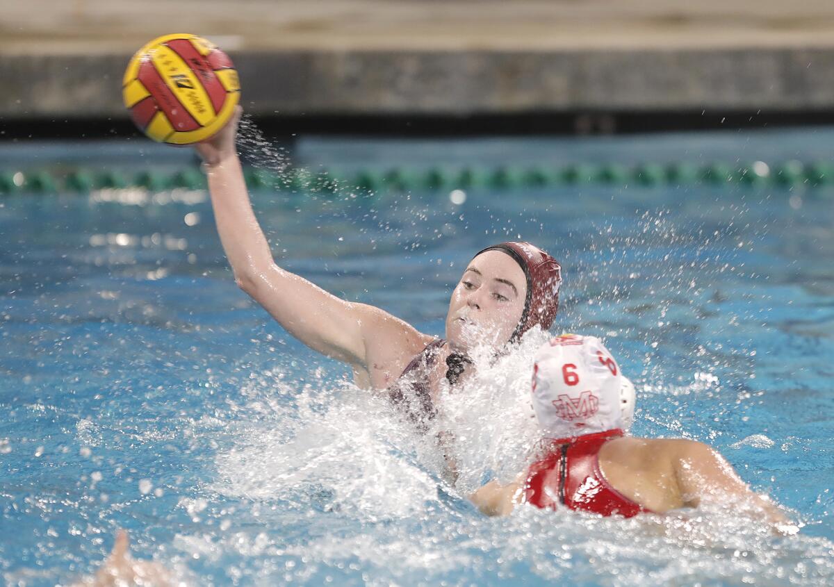 Lela McCarroll of Laguna Beach scores the go-ahead goal during girls' water polo match against Mater Dei on Friday.