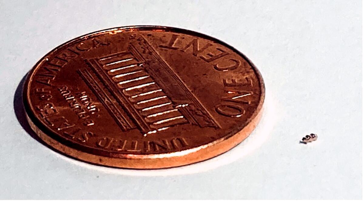 The helical Bionaut drug-delivery device, next to a penny for scale. 
