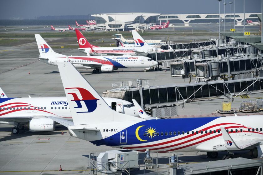 FILE - Malaysia Airlines planes taxi at a terminal while taking passengers at Kuala Lumpur International Airport in Sepang, Malaysia, on April 1, 2022. The U.S. Federal Aviation Administration has upgraded Malaysia's air safety rating to Category 1, allowing the country's carriers to expand flights to the United States after a three-year hiatus, Transport Minister Wee Ka Siong said Saturday, Oct. 1. (AP Photo/Vincent Thian, File)