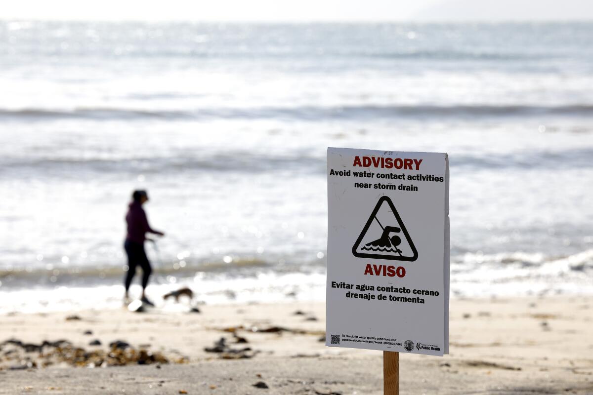 A file photo from last February from Cabrillo Beach in San Pedro has a warning sign for swimmers. 