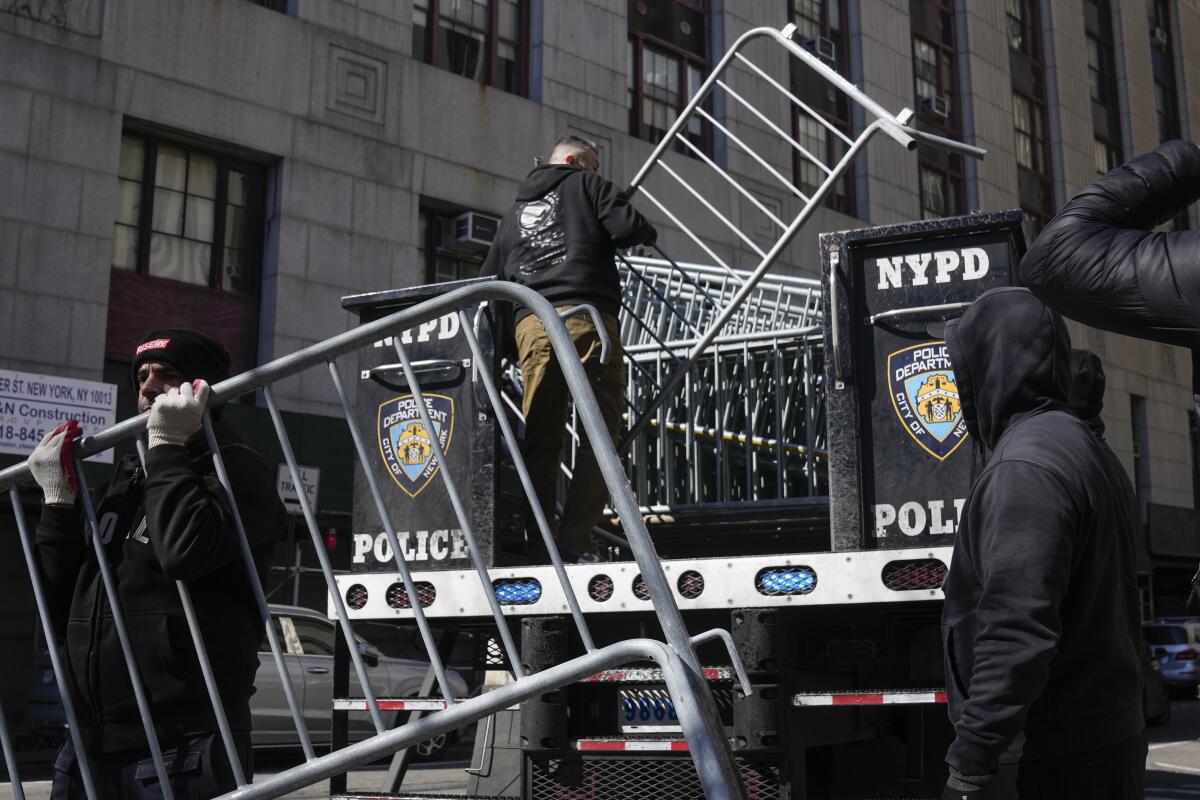 Barricades are unloaded from a truck reading "NYPD Police."