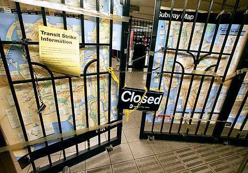 Chains and signs greet wishful riders at the Canal Street subway station in New York. The city stepped up its pressure on transit workers in hopes of forcing them back to work as millions of New Yorkers trudged to Manhattan during the second day of the strike.