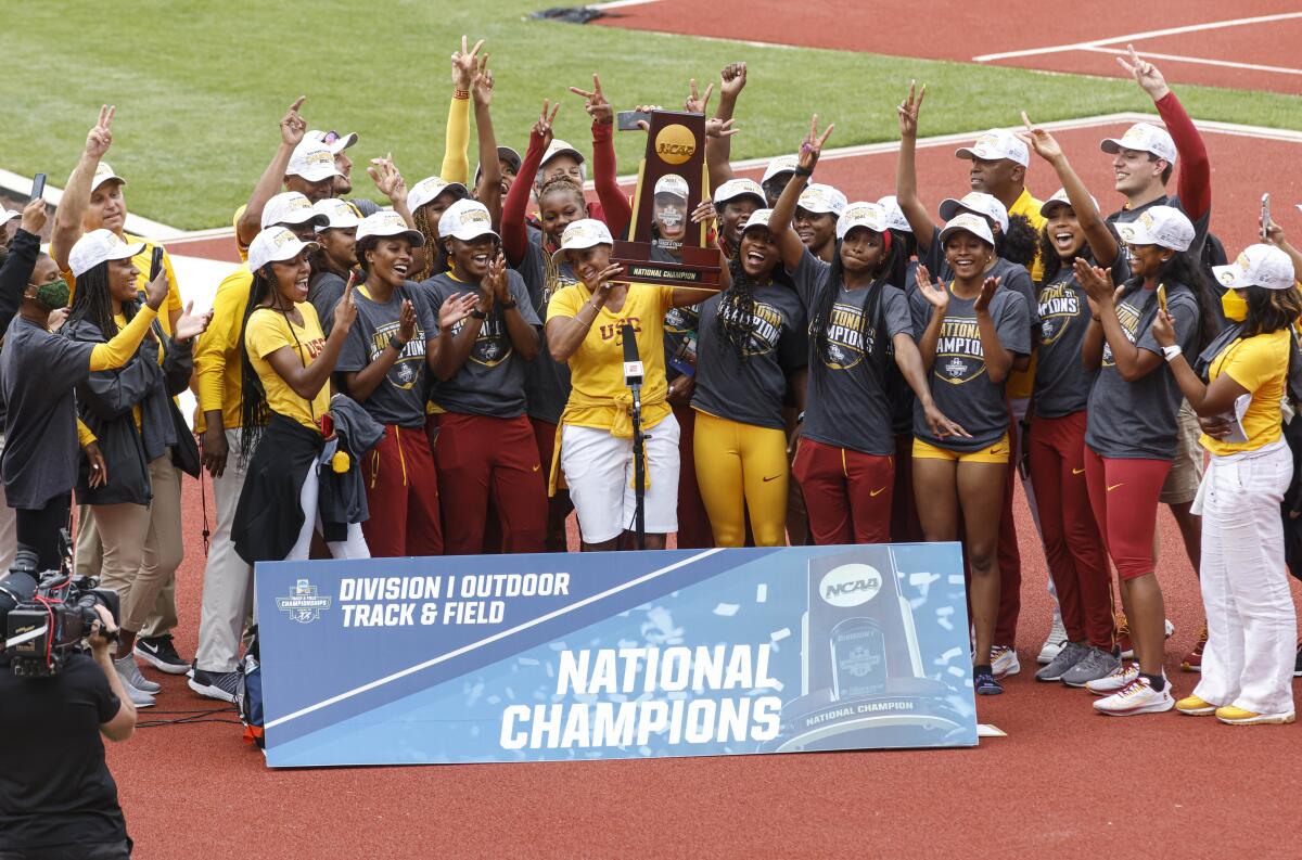 The Southern California women's team accepts the team trophy at the NCAA Division I Outdoor Track and Field Championships, Saturday, June 12, 2021, at Hayward Field in Eugene, Ore. (AP Photo/Thomas Boyd)