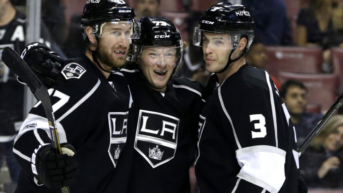 Kings forward Tyler Toffoli, center, celebrates with teammates Jeff Carter, left, and Brayden McNabb after scoring a goal against the Panthers during the first period Thursday night.