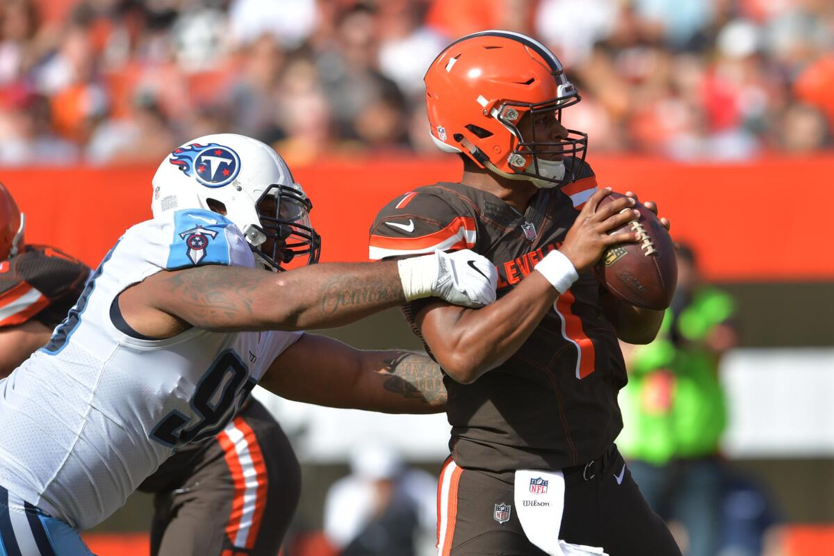 The Cleveland Brown's DeShone Kizer shakes off a sack attempt by the Titans' DaQuan Jones in the second quarter.