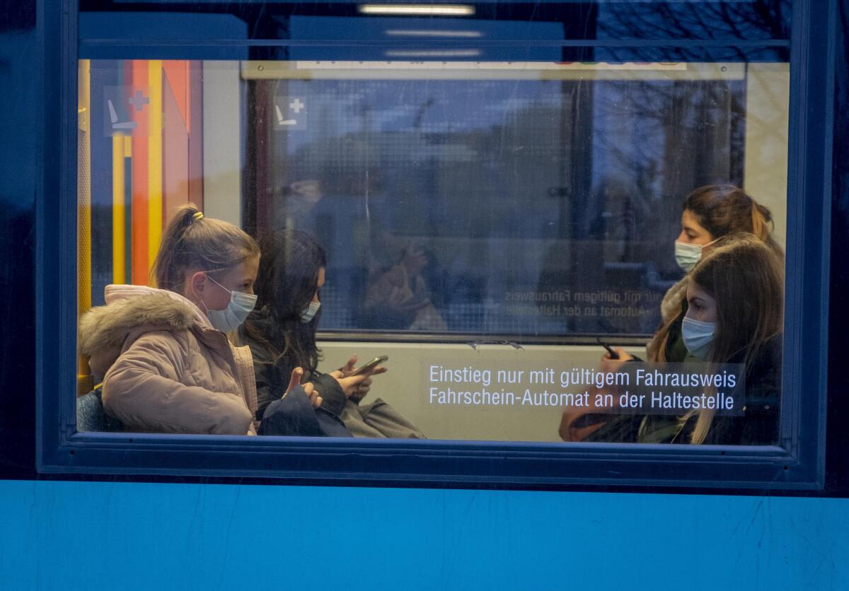 Passengers wear masks as they sit in a subway train in Frankfurt, Germany.