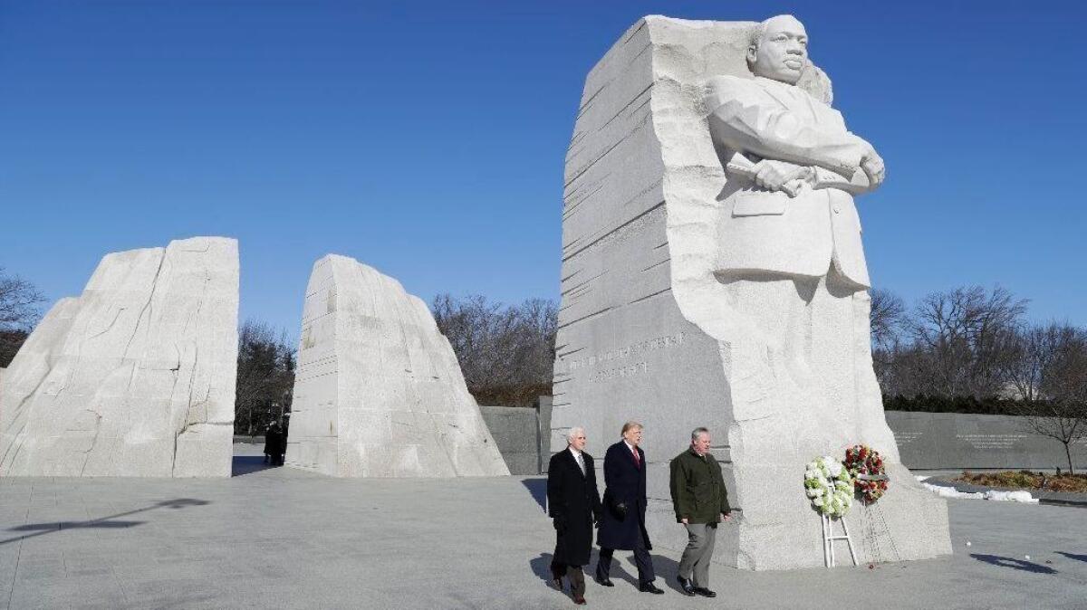 President Trump and Vice President Mike Pence, escorted by acting Interior Secretary David Bernhardt, visit the Martin Luther King Jr. Memorial on Monday.