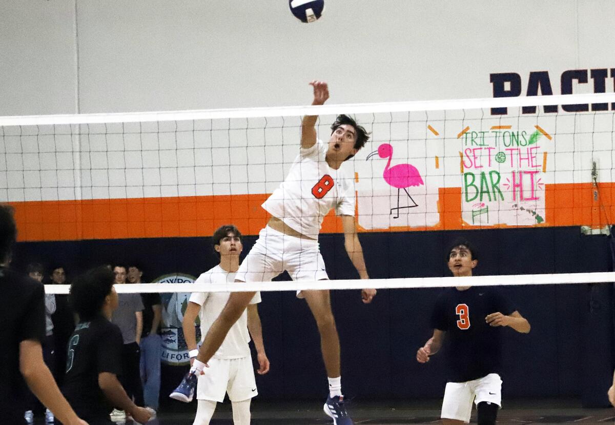 Pacifica Christian's Kallai Kumar (8) spikes the ball against Sage Hill in a nonleague boys' volleyball match on Friday.