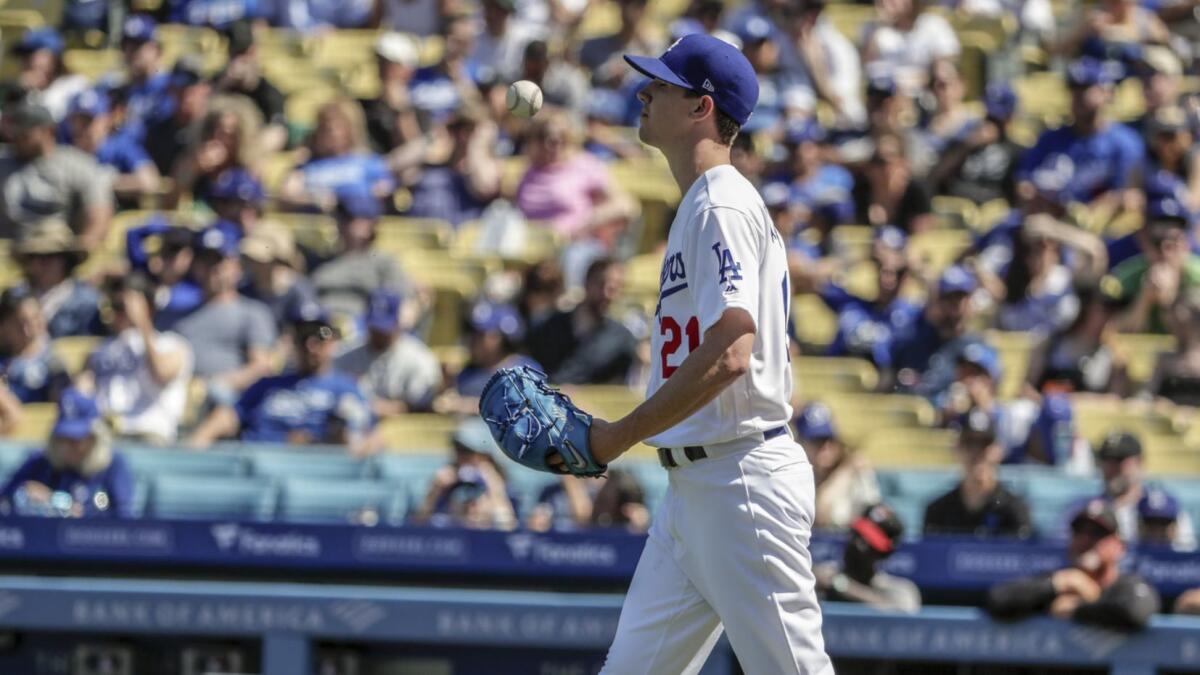 Pitcher Walker Buehler tosses the ball in apparent frustration during the fourth inning of the Dodgers' 8-7 victory over the Arizona Diamondbacks on Sunday.