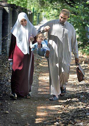 FAMILY TIME: Mohamed Abdul Azeez walks with wife Kauthar and daughter Zeyneb. The prayer leader at the SALAMÖ Islamic Center in Sacramento shaved his beard to appear less threatening.