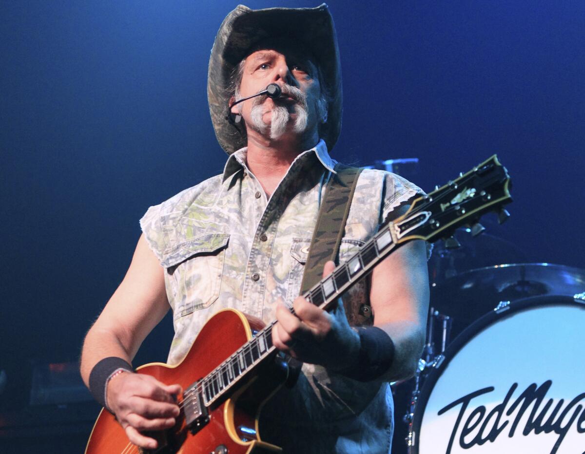 Ted Nugent strumming his guitar and singing