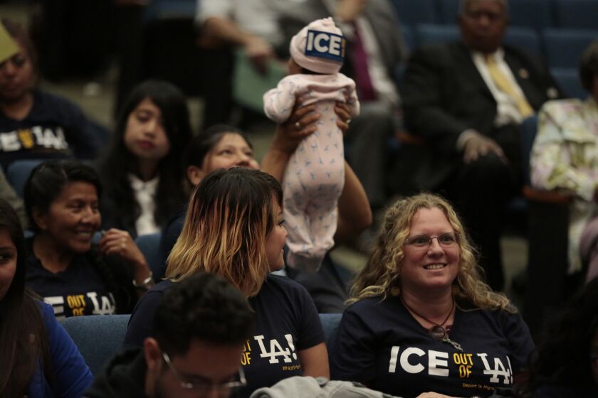 Immigration agents will be allowed back into Los Angeles County jails to identify deportable inmates under a policy made public Tuesday by Sheriff Jim McDonnell. Above, people attend a Board of Supervisors meeting in May when a previous policy allowing such cooperation was ended.