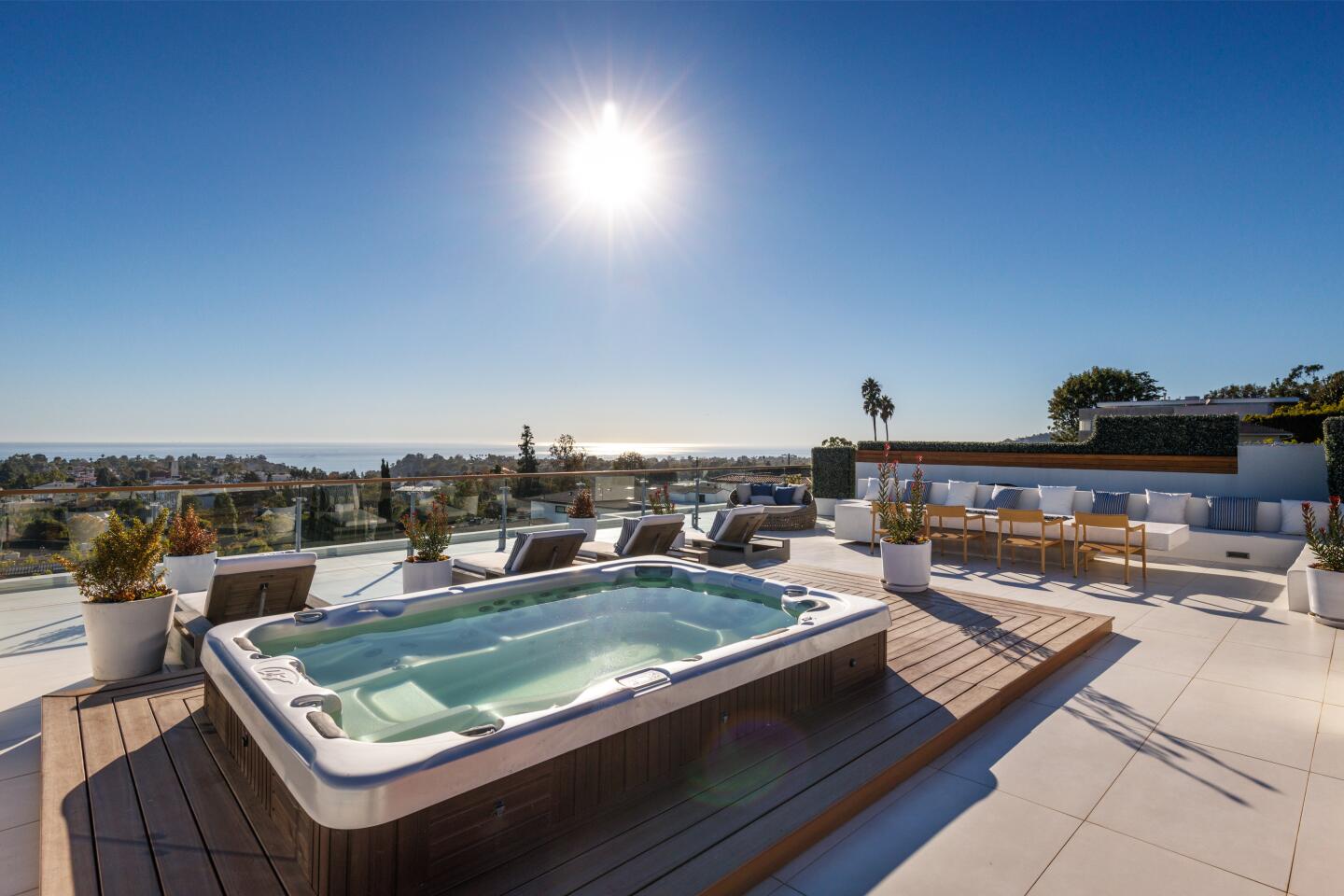 A rooftop deck with a hot tub