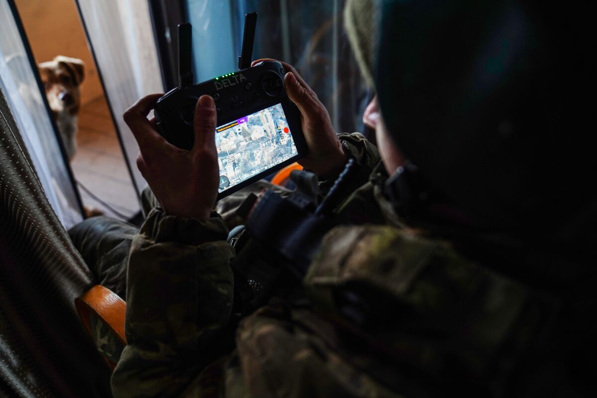 A member of Ukrainian aerial reconnaissance monitors the situation on a remote controller