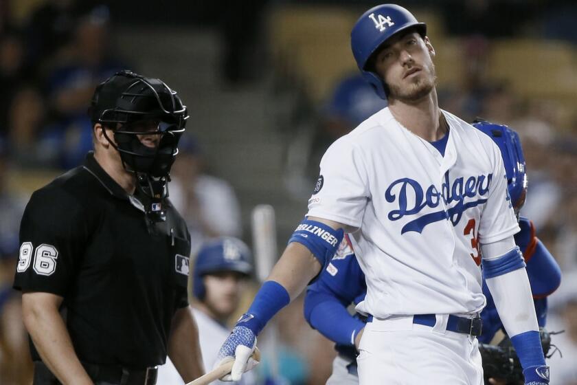 Los Angeles Dodgers' Cody Bellinger, right, laments a called strike by umpire Chris Segal, left, en route to striking out during the ninth inning of the team's baseball game against the Chicago Cubs in Los Angeles, Saturday, June 15, 2019. (AP Photo/Alex Gallardo)