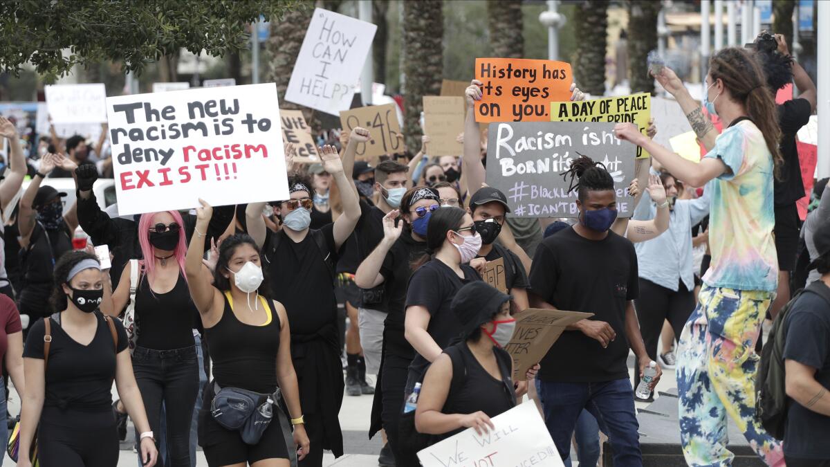 Demonstrators march June 2 in Orlando, Fla., during a protest over the death of George Floyd.