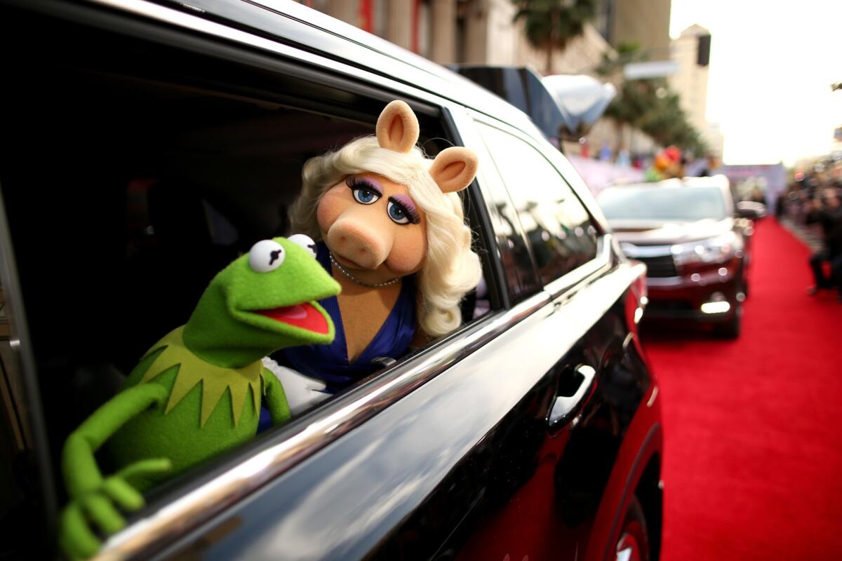 Kermit the Frog and Miss Piggy arrive at the world premiere of "Muppets Most Wanted" at the El Capitan Theatre in Hollywood.