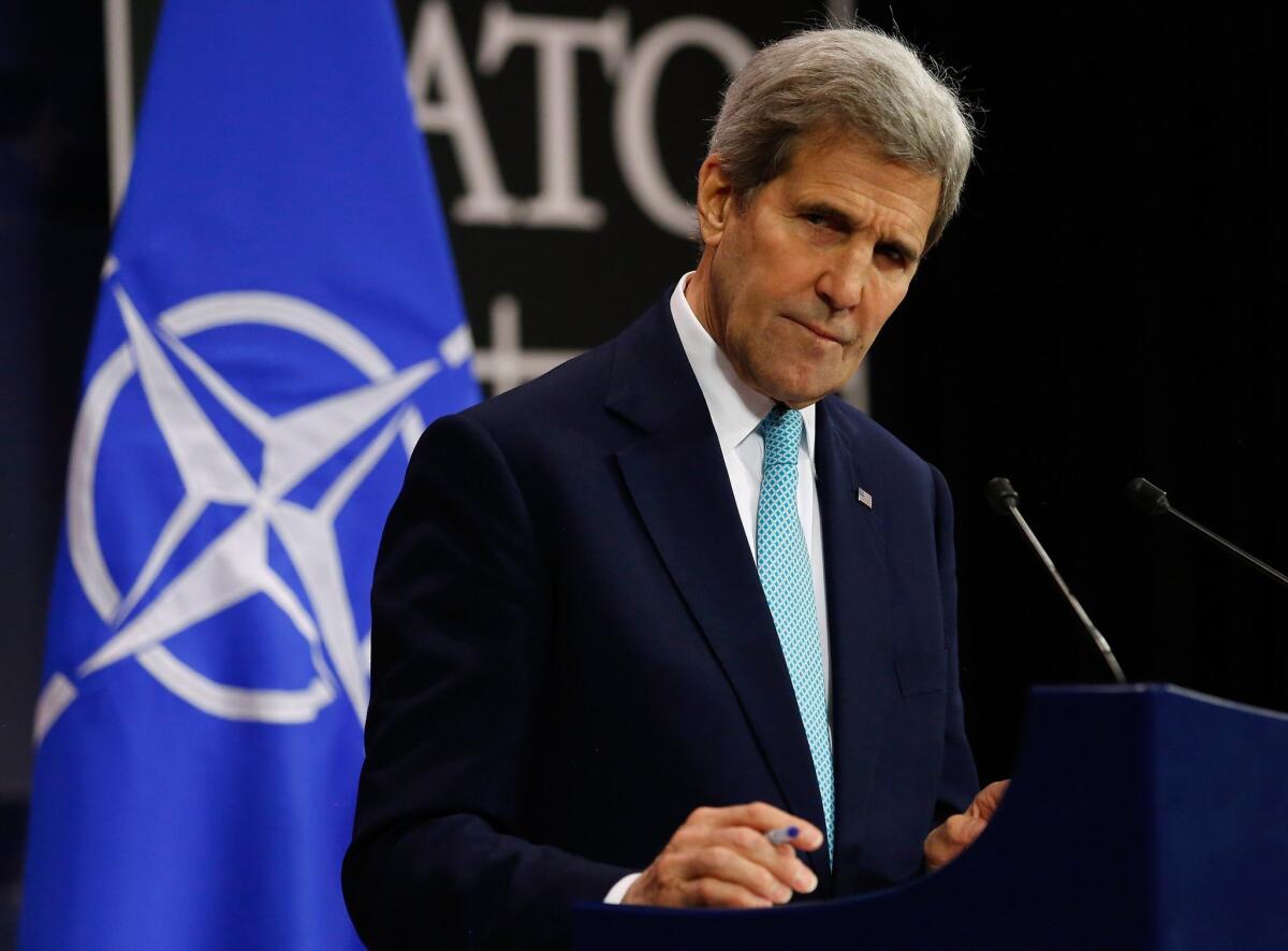 U.S. Secretary of State John Kerry listens to a question during a news conference at the NATO ministerial meetings in Brussels.