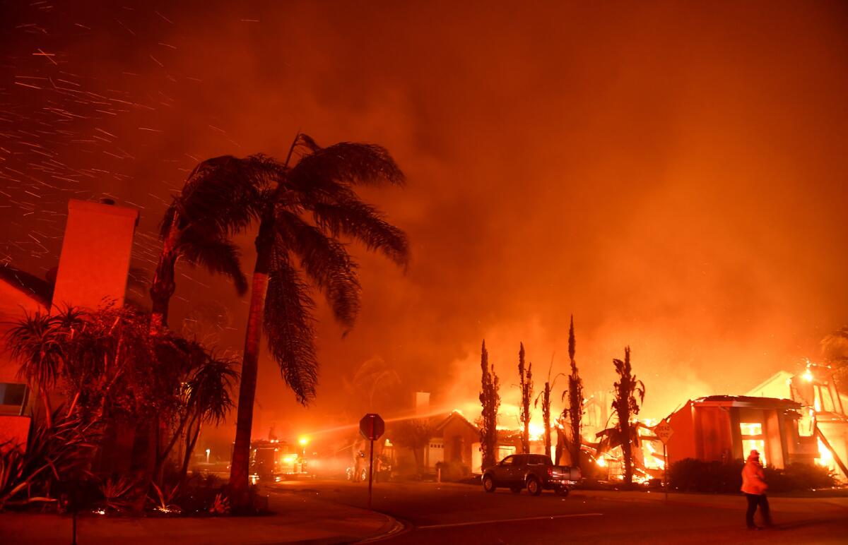 Flames rage on Churchwood Drive as the Woolsey fire tears through Oak Park.