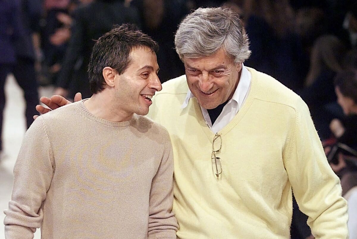FILE - American-Greek designer Peter Speliopoulos, left, and Nino Cerruti talk on the catwalk after their fall-winter ready-to-wear fashion show presentation in Paris, Thursday March 15, 2001. Cerruti, the Italian fashion designer credited with revolutionizing menswear in the 1960s and who gave Giorgio Armani his first fashion break, has died, Italian media reported Saturday, Jan. 15, 2022. He was 91. (AP Photo/Michel Euler, File)