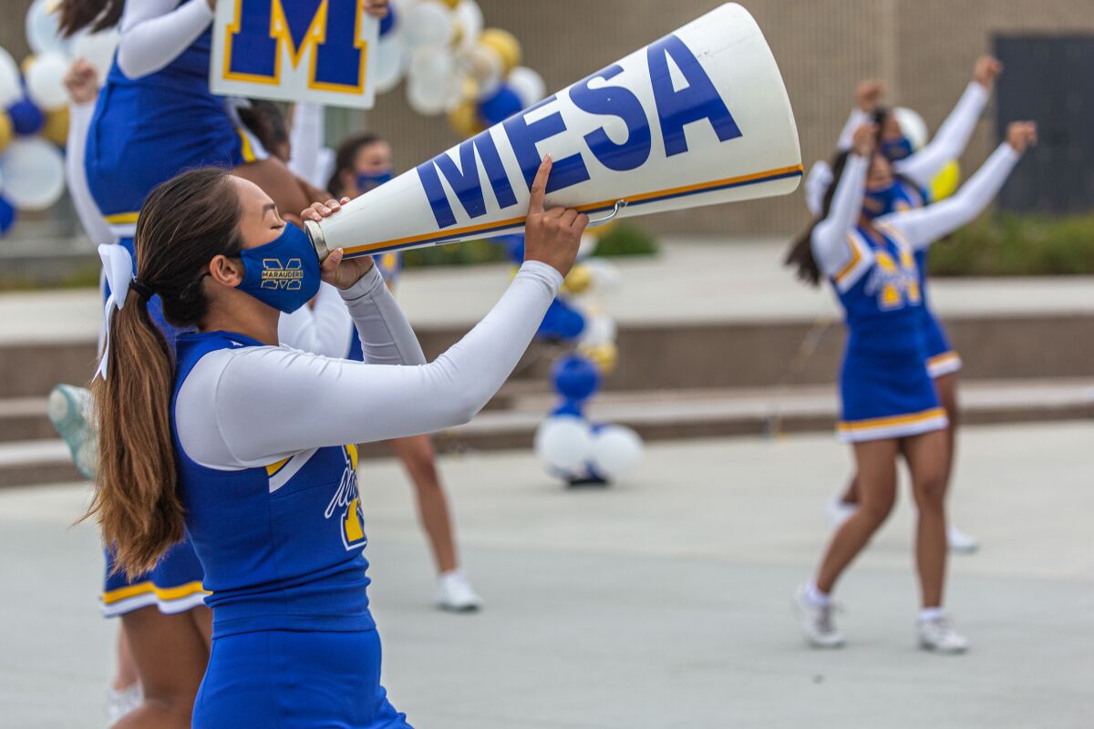 Cheerleaders perform a routine before class on the first day of school at Mira Mesa High School on Monday, Aug. 30, 2021