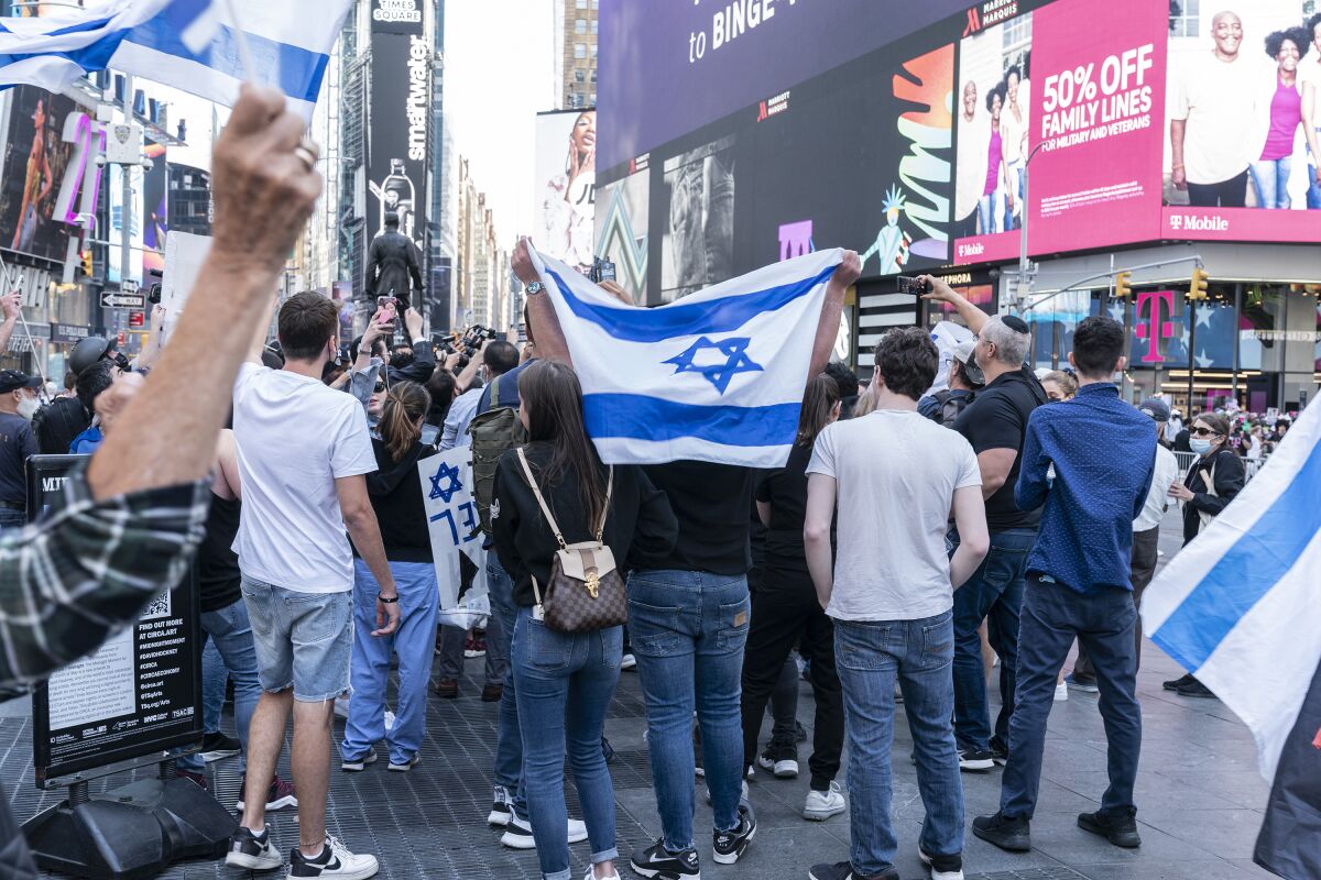People hold Israeli flags and signs in New York City