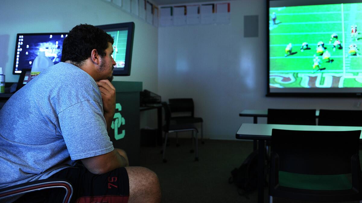 USC center Max Tuerk watches game film as part of his continuing effort to make a smooth transition from offensive guard and offensive tackle.