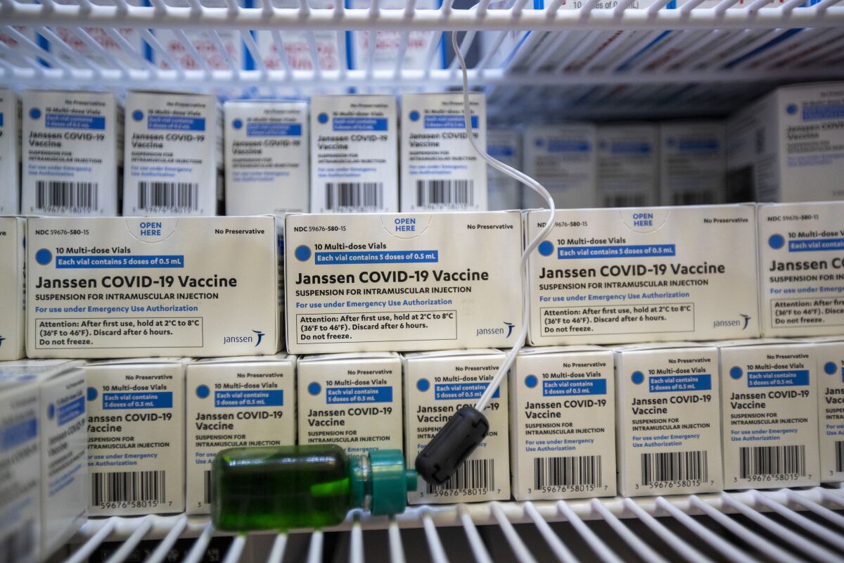 Boxes of Johnson & Johnson's COVID-19 vaccine sit on shelves. 