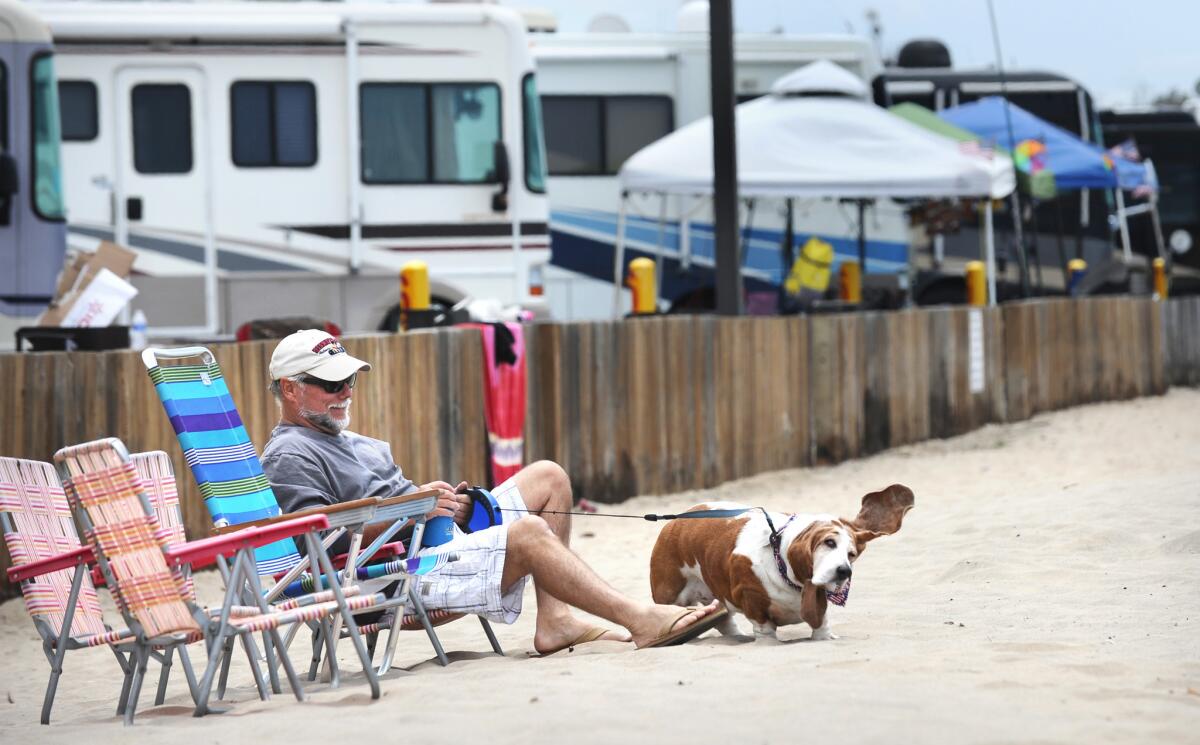 Rick Porter relaxes on the beach Friday at Dockweiler State Beach campground at the start of Memorial Day weekend.