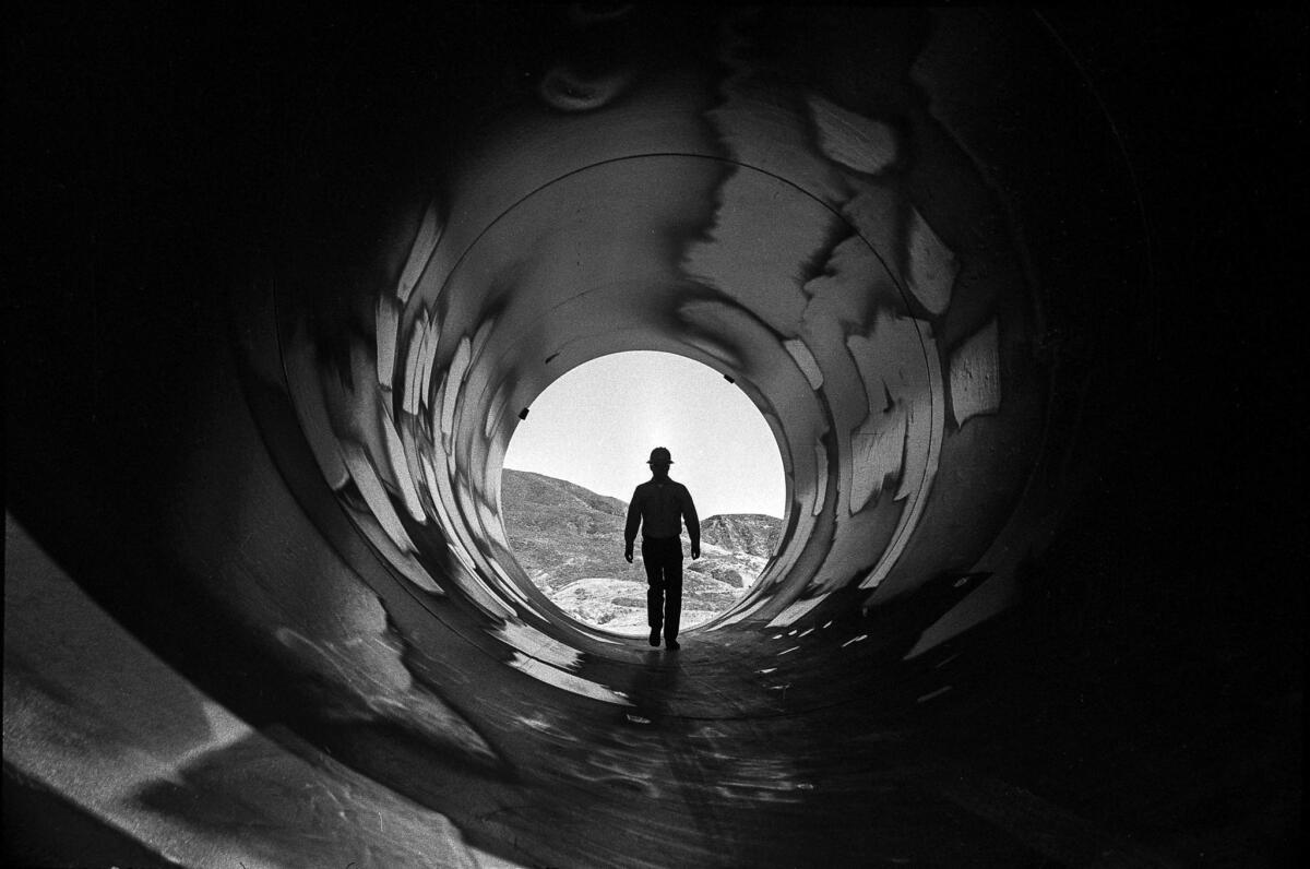 March 1976: A worker walks through a water pipe during construction of the Castaic Hydroelectric Power Plant.