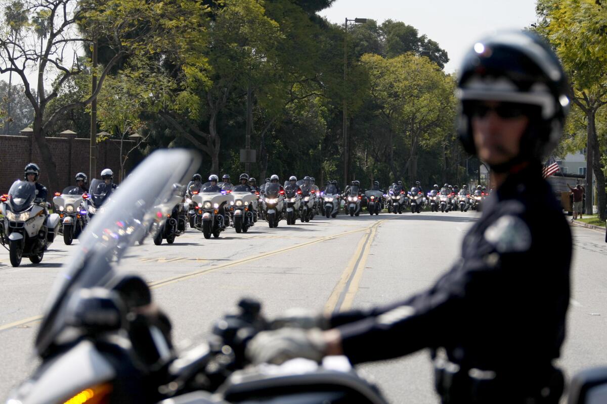 A large procession of Los Angeles Police officers on motorcycle arrive for LAPD Officer Nicholas Lee's funeral at Forest Lawn Glendale on Thursday, March 13, 2014. Officer Lee died in the line of duty when a large truck collided with his patrol car last week in Beverly Hills.