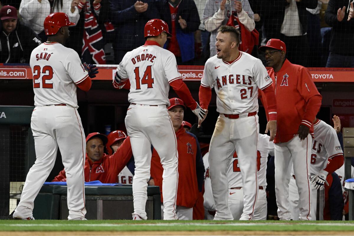 Angels star Mike Trout, second from right, celebrates with Logan O'Hoppe, after O'Hoppe hit a grand slam.