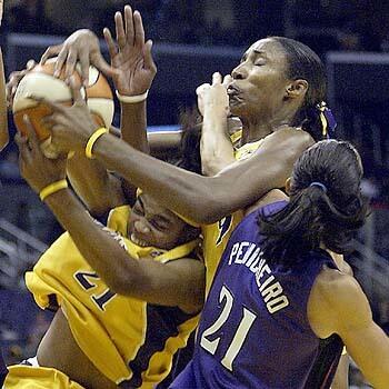 The Sparks' Tamecka Dixon (left), Lisa Leslie (right) and Sacramento Monarchs' Ticha Penicheiro go after a rebound in the second half. The Sparks lost 73-58.