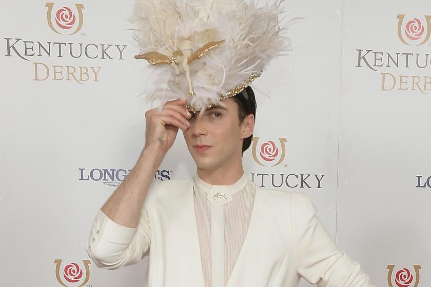 Figure skater Johnny Weir, shown at the 104th Kentucky Derby, announced Tuesday that he and husband Victor Voronov are back together. And, yes, that's Pegasus on the hat.