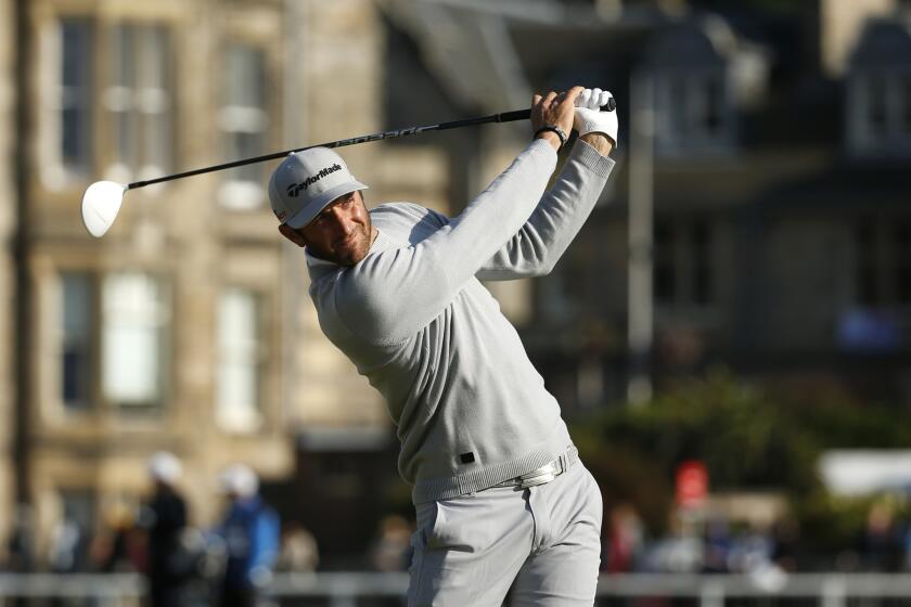 Dustin Johnson drives the ball from the second tee Friday during the second round of the British Open at the Old Course, St. Andrews, Scotland.