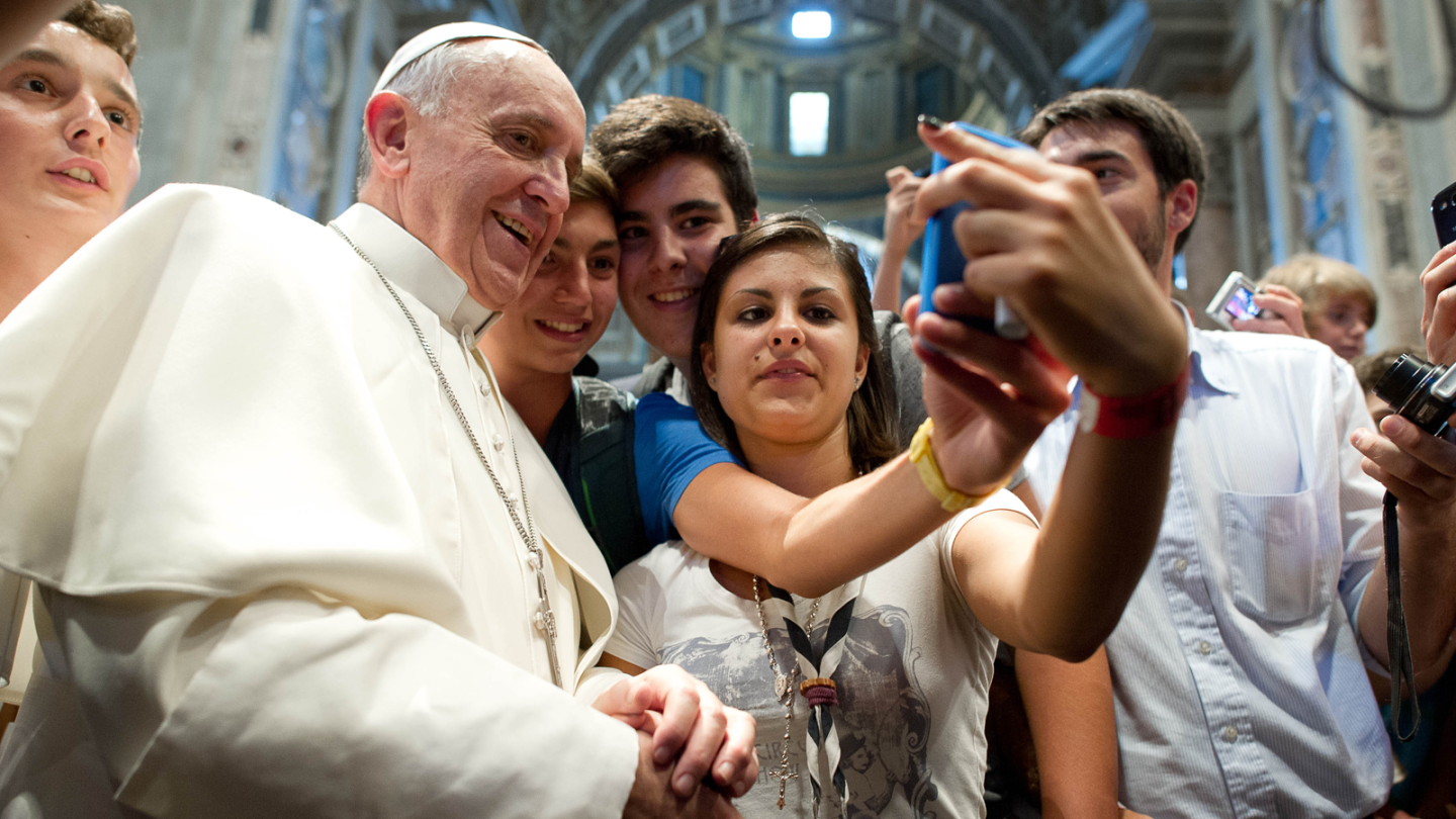 At St. Peter's Basilica, Pope Francis and teens squeeze in for a selfie in August 2013.