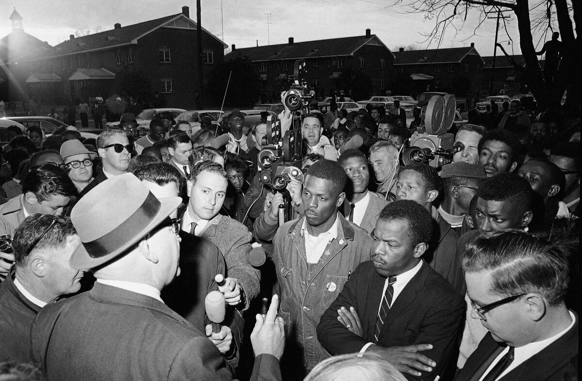 FILE - In this Feb. 23, 1965, file photo, Wilson Baker, left foreground, public safety director, warns of the dangers of night demonstrations at the start of a march in Selma, Ala. Second from right foreground, is John Lewis of the Student Non-Violent Committee. Lewis, who carried the struggle against racial discrimination from Southern battlegrounds of the 1960s to the halls of Congress, died Friday, July 17, 2020. (AP Photo/File)
