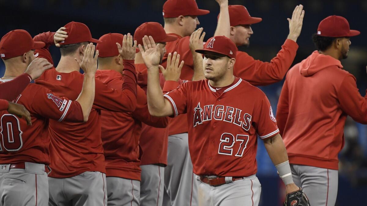 Mike Trout celebrates with his teammates after the Angels defeated Toronto 3-1 on June 18.